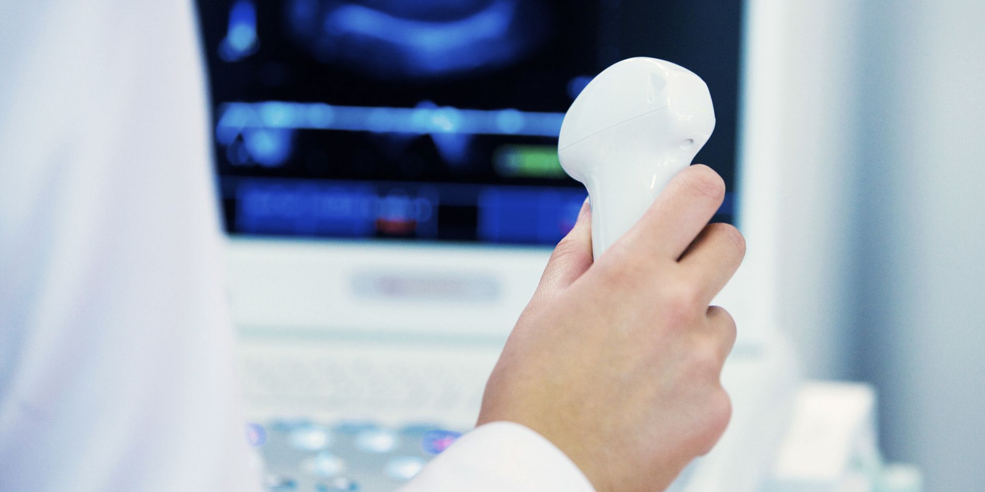doctor holding an ultrasound scanner to check vascular issues