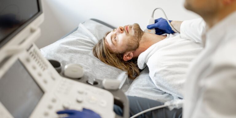 doctor checking for carotid artery disease symptoms on a young male patient