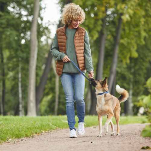 oman walking her dog after undergoing a new treatment for osteoarthritis of the knee