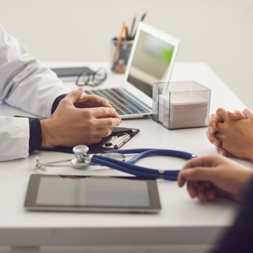 patient talking to their doctor who treats osteoarthritis