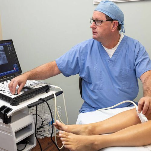 Dr. Pollock performing a vein exam