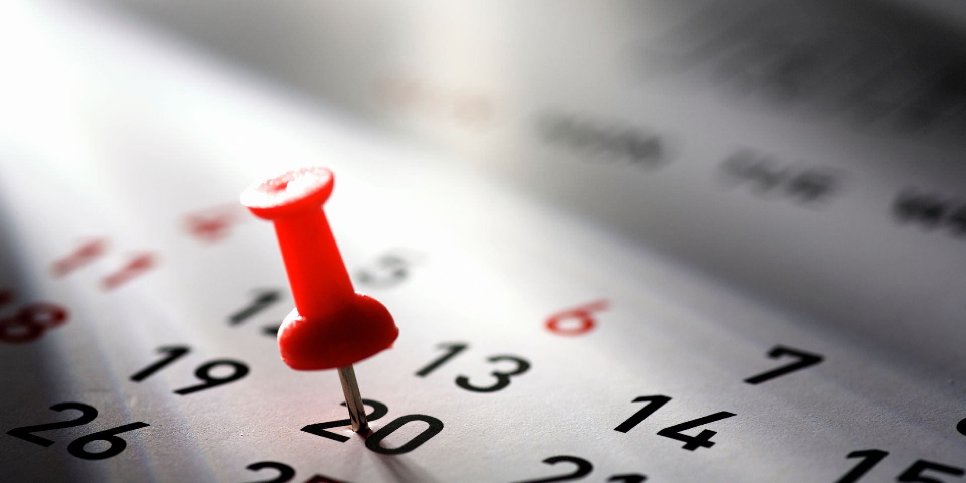 push-pin pressed into a calendar