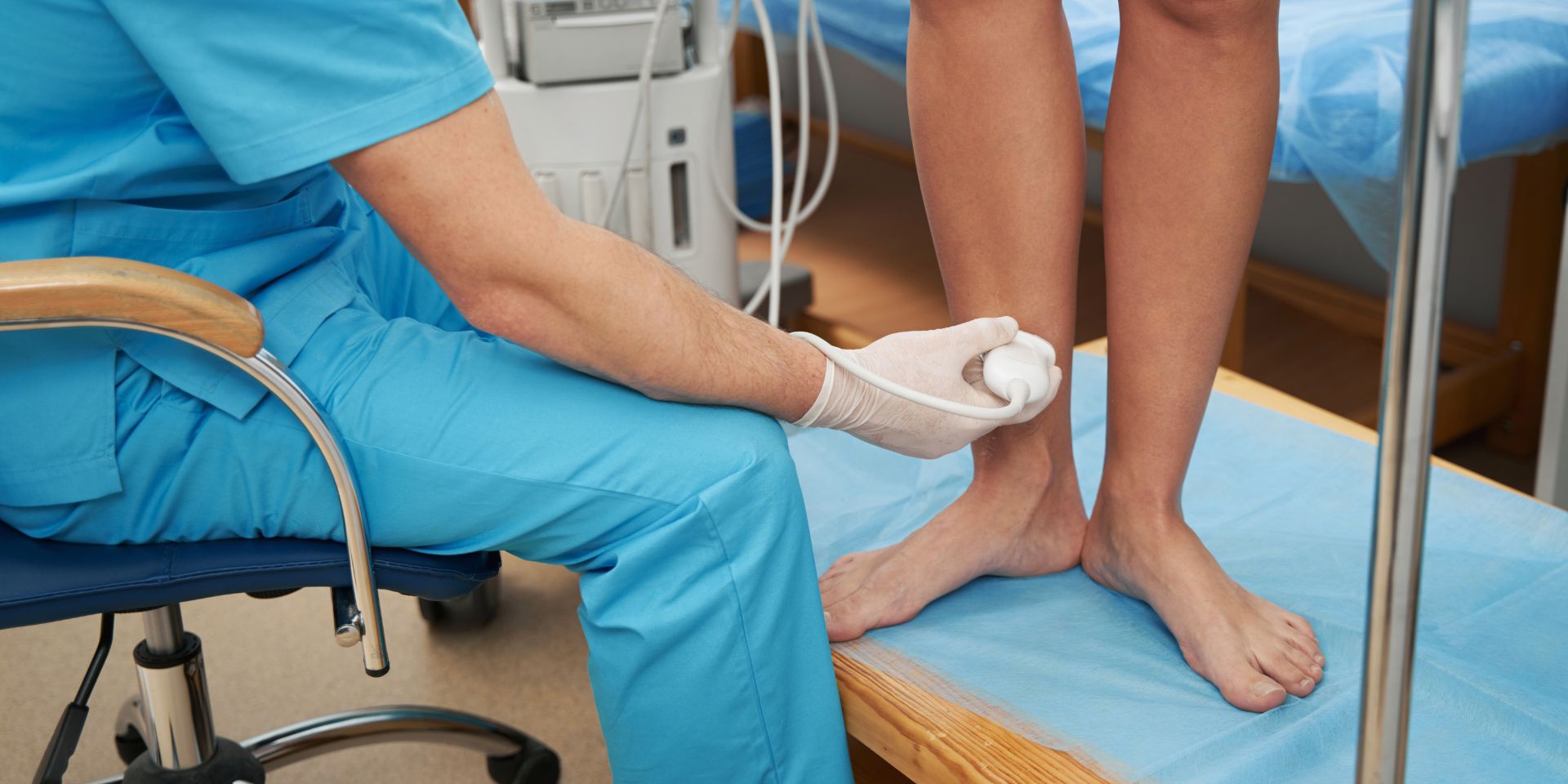 Vascular surgeon using ultrasound to examine a patient’s leg veins