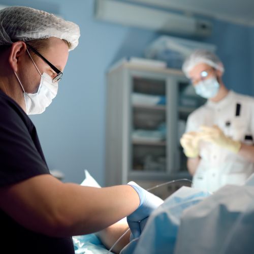 Vascular surgeon and tech performing endovascular procedures