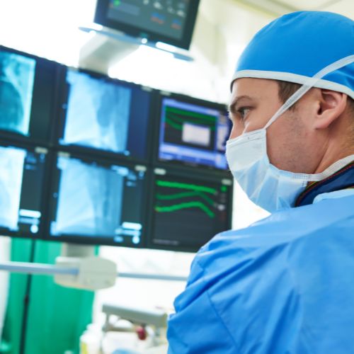 endovascular surgeon looking at a patient’s X-rays