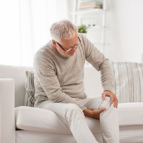 senior woman with leg pain in bed