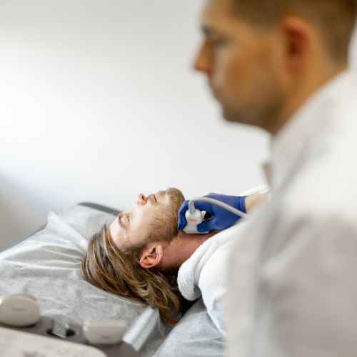 Doctor examining a man’s carotid artery