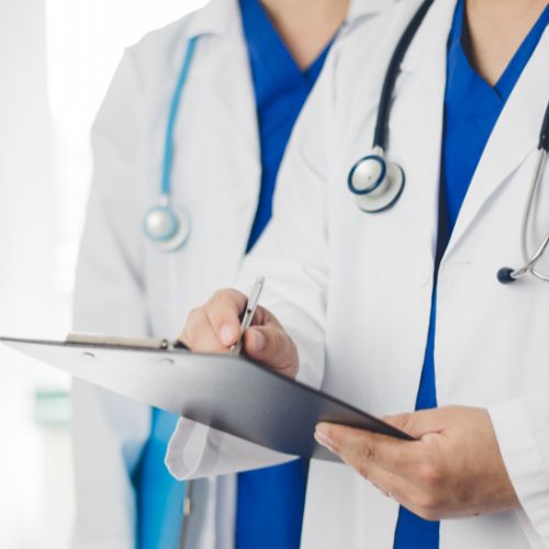 two vascular surgeons reviewing a patient’s carotid artery disease notes