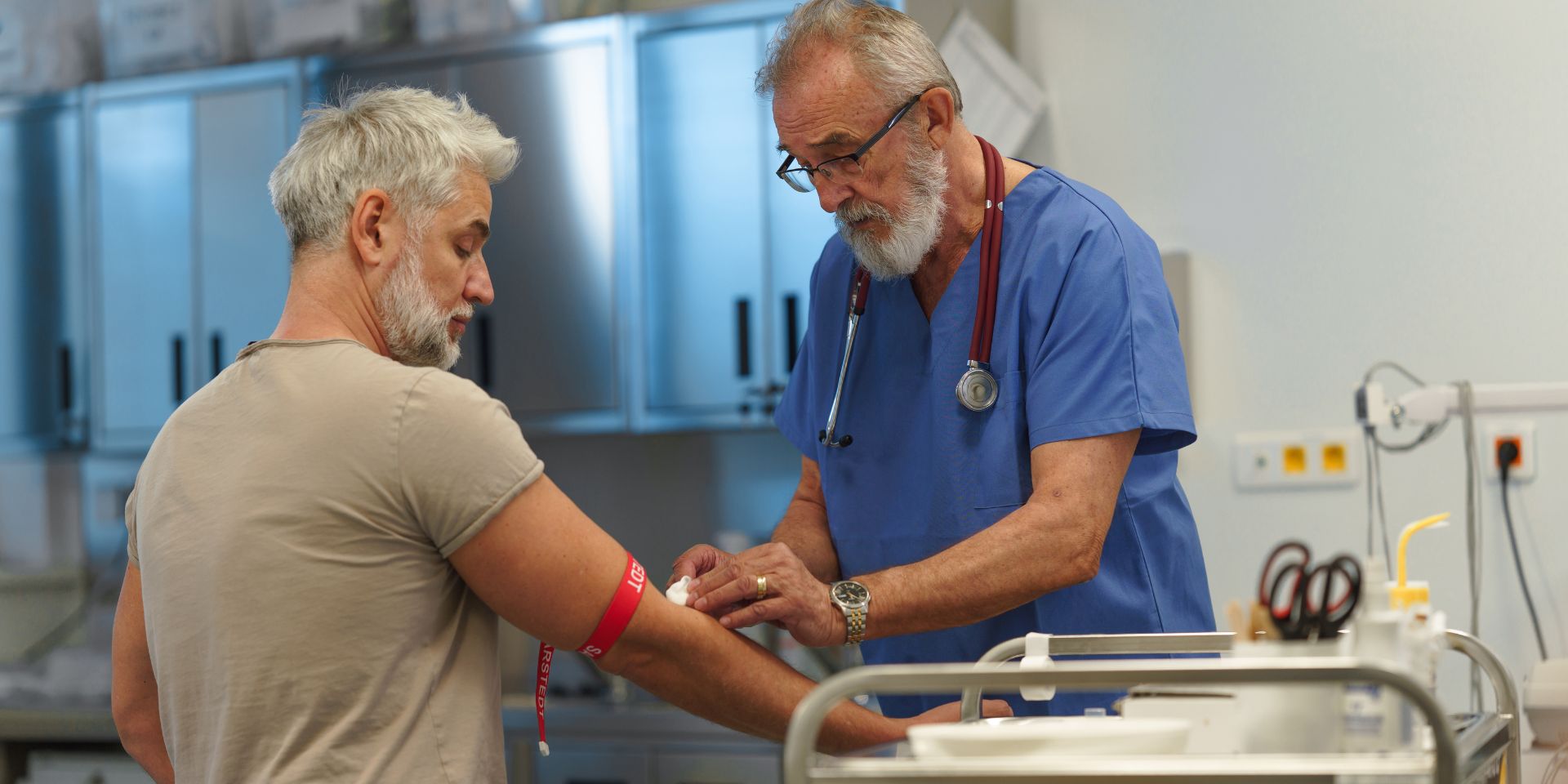 vein doctor applying a bandage to a patient after drawing blood