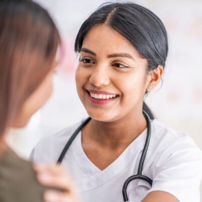 vein doctor putting her hand on a patient’s shoulder in encouragement