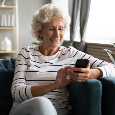 woman searching sclerotherapy near me on her phone