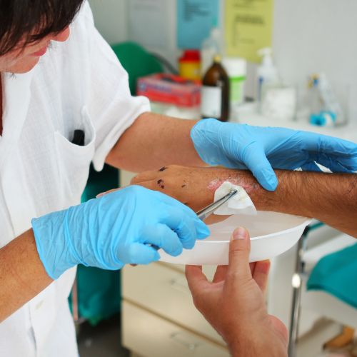doctor treating a patient’s wound