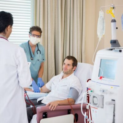 man with dialysis access being prepared by a doctor and nurse