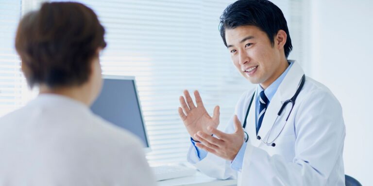 vascular specialist discussing non-surgical procedures for chronic limb pain with a patient