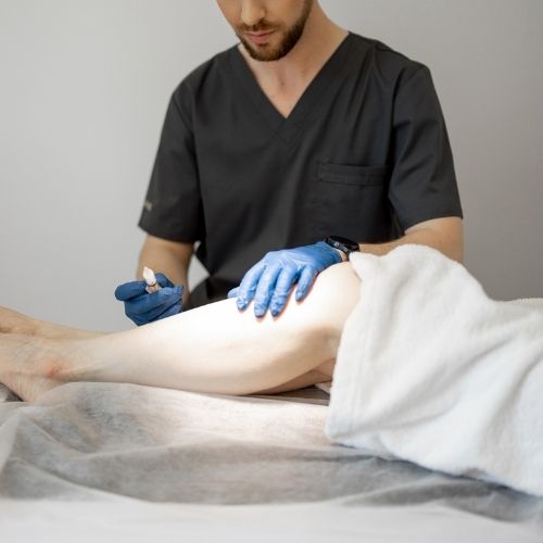 Vascular specialist providing sclerotherapy treatment on a patient